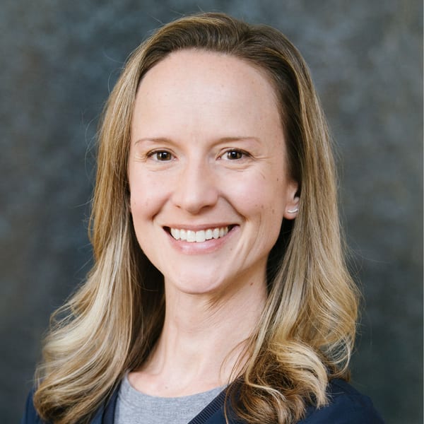Jaylene Kilduff, smiling, with long blonde hair, against a mottled grey backdrop